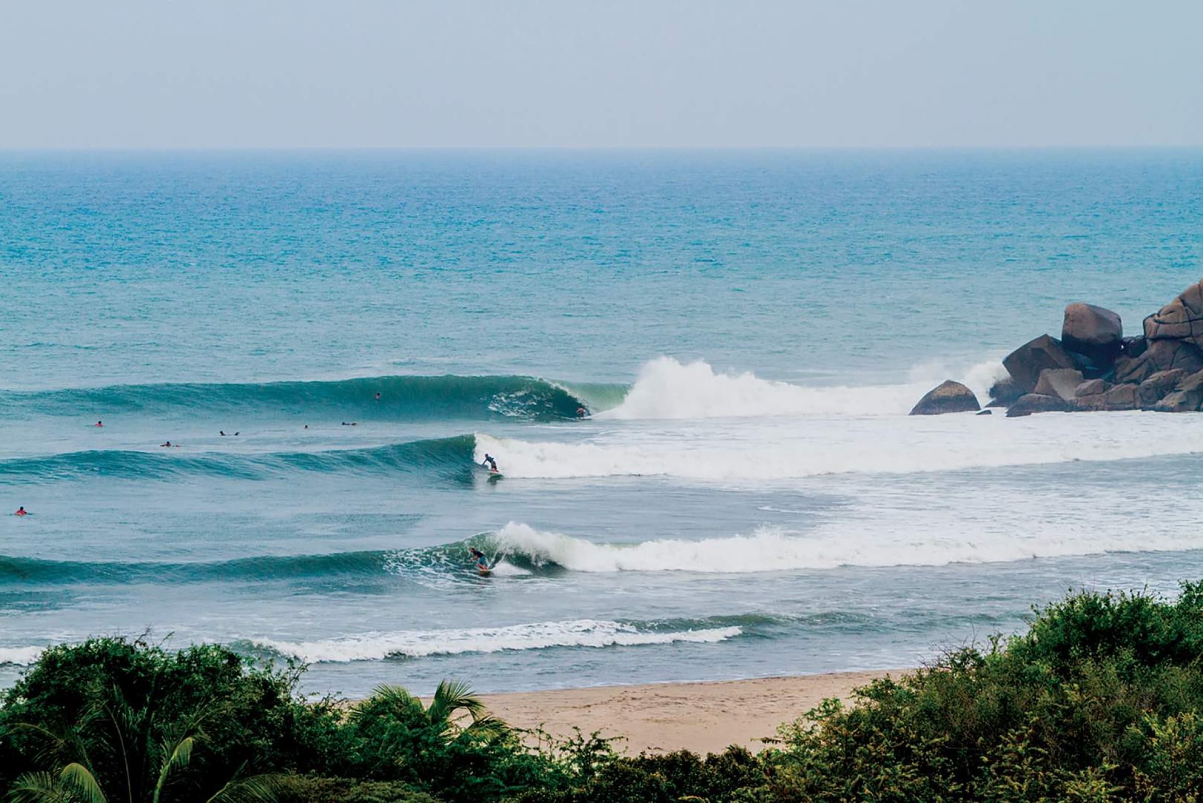 Surfers lined up at the Barra de la Cruz point break